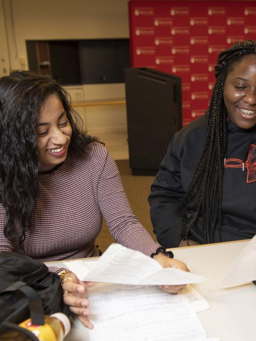 Two students study together at a table